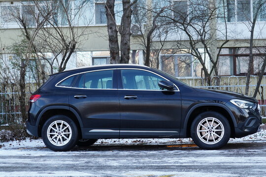 Bucharest, Romania &ndash; December 26, 2025:  Side view of Mercedes GLA 200 black car parked near block of apartments
