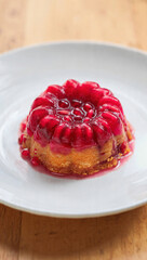 Freshly baked homemade raspberry cheesecake on a white plate makes a delicious gourmet dessert featuring sweet red fruit and smooth cream