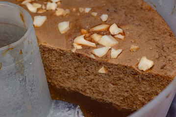 A seaweed-based dish. Also known as Agar-agar Cincau. A traditional homemade dessert with a chocolate texture and walnut pieces on top.