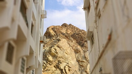 Urban Rock Cliff Vertical Canyon View. Neutral Beige Blue Sky