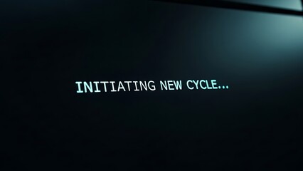 Computer screen displays initiating new cycle message in dark room