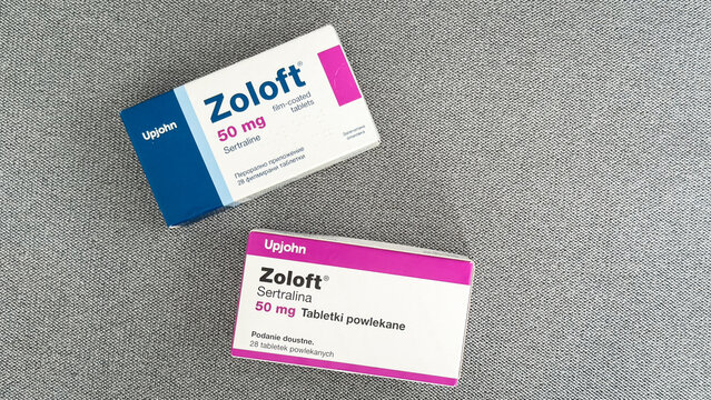 Two boxes of Zoloft 50 mg sertraline antidepressant medication from Upjohn placed on a gray textile surface, used in healthcare, psychiatry