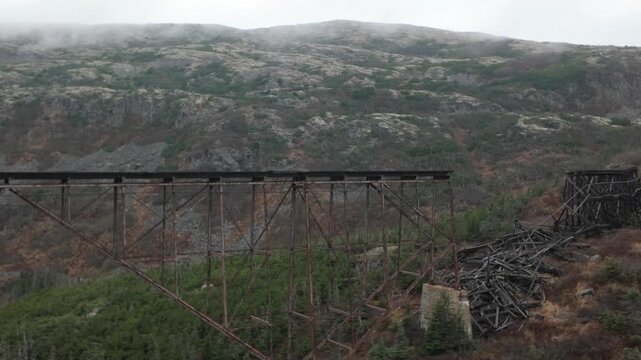 Gimbal shot from a moving train of a collapsed railroad bridge on the White Pass Yukon Route scenic railway in Skagway, Alaska. 4K at 30 FPS