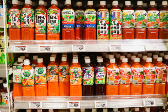 TOKYO, JAPAN - December 31, 2025: Various bottles of fruit and vegetable juices, mostly Kagome brand, on shelves in a supermarket.