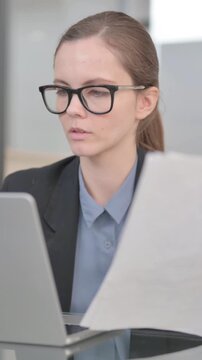 Businesswoman Doing Online Data Entry with Laptop and Docuemtns, vertical video