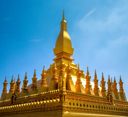 Fototapeta premium Breathtaking closeup of the Great Stupa Pha That Luang (the national symbol of Laos) in downtown Vientiane, Laos