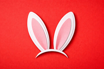 Minimal Easter bunny ears made of paper on red background