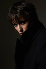 Mistery girl with short hair. Female face in dark