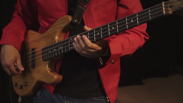 musician playing electric bass in rehearsal music studio