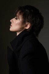 beautiful girl with short hair. Female profile in dark
