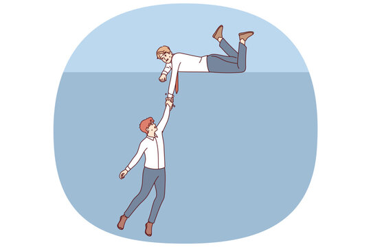 Business man extends helping hand to colleague who is falling into abyss, showing support in difficult situation. Support from corporate partner for human in trouble and at risk of bankruptcy