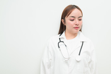 Fototapeta premium Portrait of young Asian female doctor against white background looking pensive
