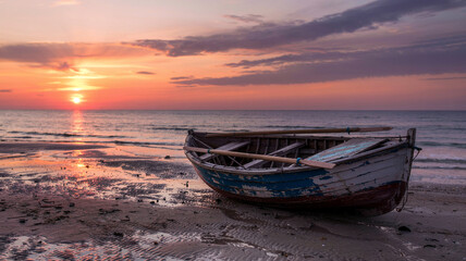 The sun sets slowly behind the solar panels