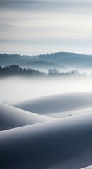 Obraz premium Ethereal landscape of rolling hills shrouded in morning mist.