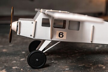 Vintage toy airplane with number 6 on its side, a detailed close-up shot