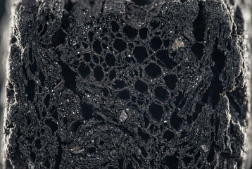 Macro texture of black Biochar honeycomb structure, porous carbon charcoal material for agricultural soil improvement and sustainable filtration background.