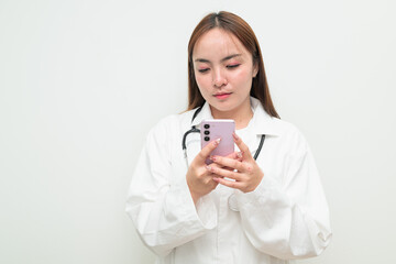 Portrait of young Asian female doctor against white background using phone sending sms