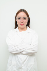 Portrait of Asian female research scientist against white background with arms crossed