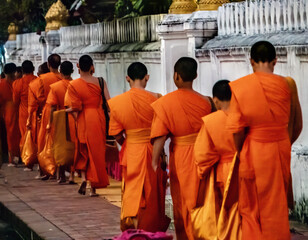 Monks' Alms Giving (Sai Bat) Procession in Lunag Prabang, Laos. Monks walk in single file, barefoot, from city's monasteries