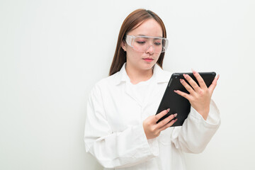 Portrait of Asian female research scientist against white background using digital tablet computer