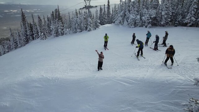 Aerial shot pulls out to reveal a person, standing on a snowy slope at Mount Sima ski resort near Whitehorse, Yukon.