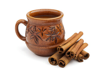 Warm cinnamon spice drink in rustic ceramic mug with cinnamon sticks