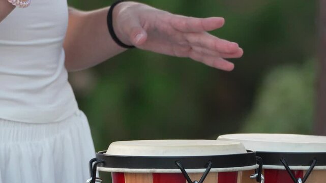 Drums, Playing, Hands, Woman performing bongo music outdoors with rhythmic energy