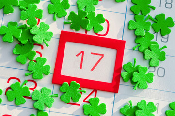 St Patrick's Day background. Green quatrefoils above the calendar with framed 17 March date, St Patrick's day holiday concept