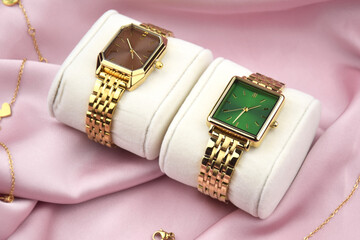 Closeup minimal fashion wristwatch for women on pink background.