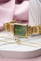 Closeup minimal fashion wristwatch for women on pink background.