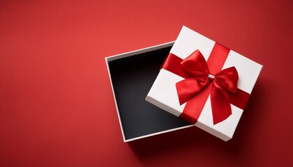 Open White Gift Box With Red Ribbon And Lid On A Vibrant Red Background