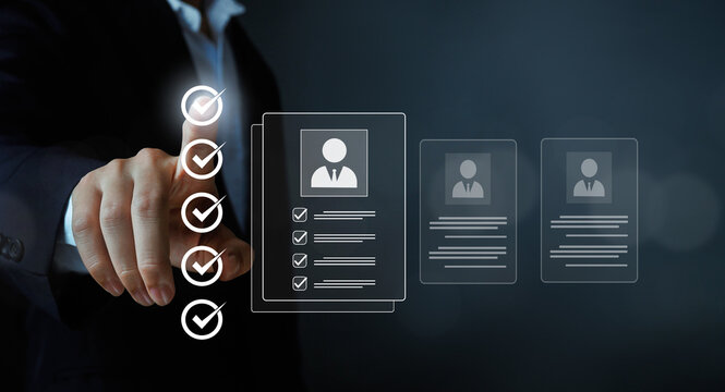 Businessman selecting candidate profile with checklist icons on virtual screen, human resources recruitment concept, resume screening, hiring process, talent management, HR technology.