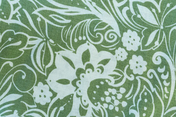 Flower swirl pattern on olive green material