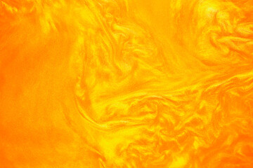 Shimmering gold abstract background. Liquid gold texture waves and swirls. Beautiful shiny yellow...