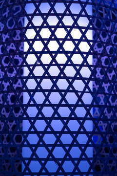 a close-up of a lampshade made from a bamboo or wooden weave with a geometric hexagram