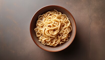 Overhead Shot Of Noodles In A Bowl On A Textured Surface