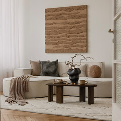 Earthy modern interior with round sofa, minimal coffee table, and large textured wall art in a soft...