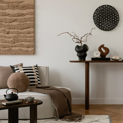 Elegant console table styling with artistic sculptures, ceramics, and decorative elements. A...
