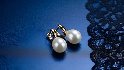 Elegant gold earrings with lustrous pearls on delicate black lace