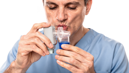 Closeup of a respiratory therapist demonstrating proper inhaler use with a spacer device emphasizing stepwise technique for effective asthma management isolated on white.