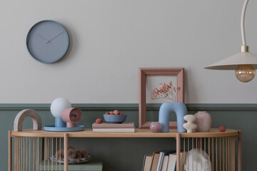 Creative composition of living room interior with mock up poster frame, wooden sideboard, vase with...
