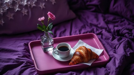 Cozy morning breakfast setup with coffee and croissant in bed