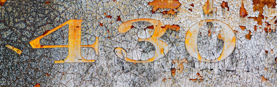 Background with the numbers 4, 3, and 0 in damaged and chipped paint on weathered and rusty metal