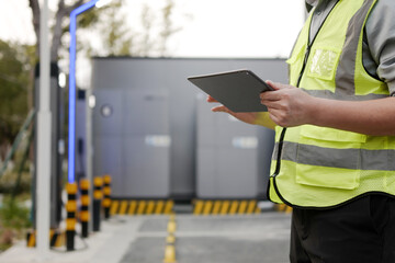 asian Worker uses tablet at charging station