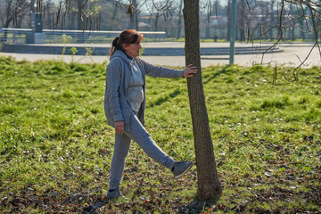 Old woman stretching before running