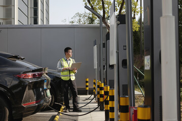 asian Worker uses laptop at charging station