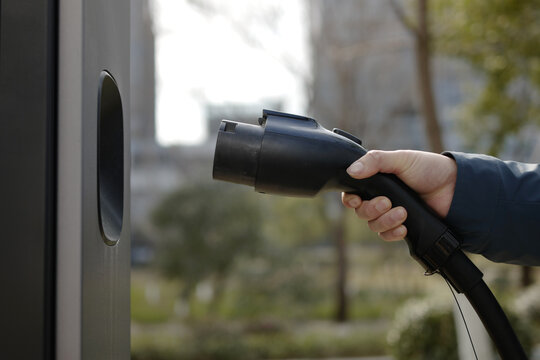 Plugging EV charger into charging port