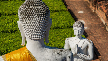 Two Buddha statues facing each other within historic temple grounds