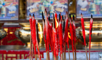 Burning red incense sticks used for prayer and worship at temple