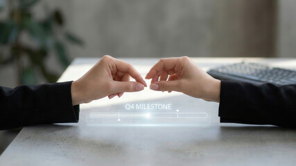 Business hand gesture high level planning concept with q4 milestone hologram progress bar on office desk